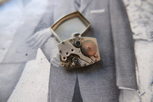 Load image into Gallery viewer, Vintage watch mechanism on a gray suit jacket