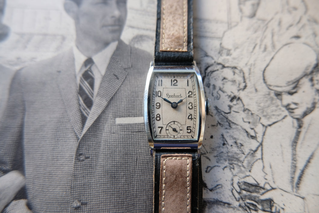 Vintage wristwatch with brown leather strap on a textured background